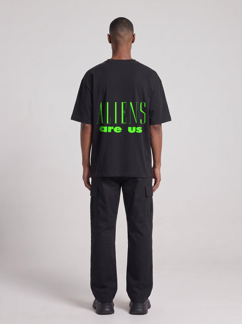 Aliens Are Us Neon — Drop Shoulder T-Shirt in Black Beauty, back, worn by male model