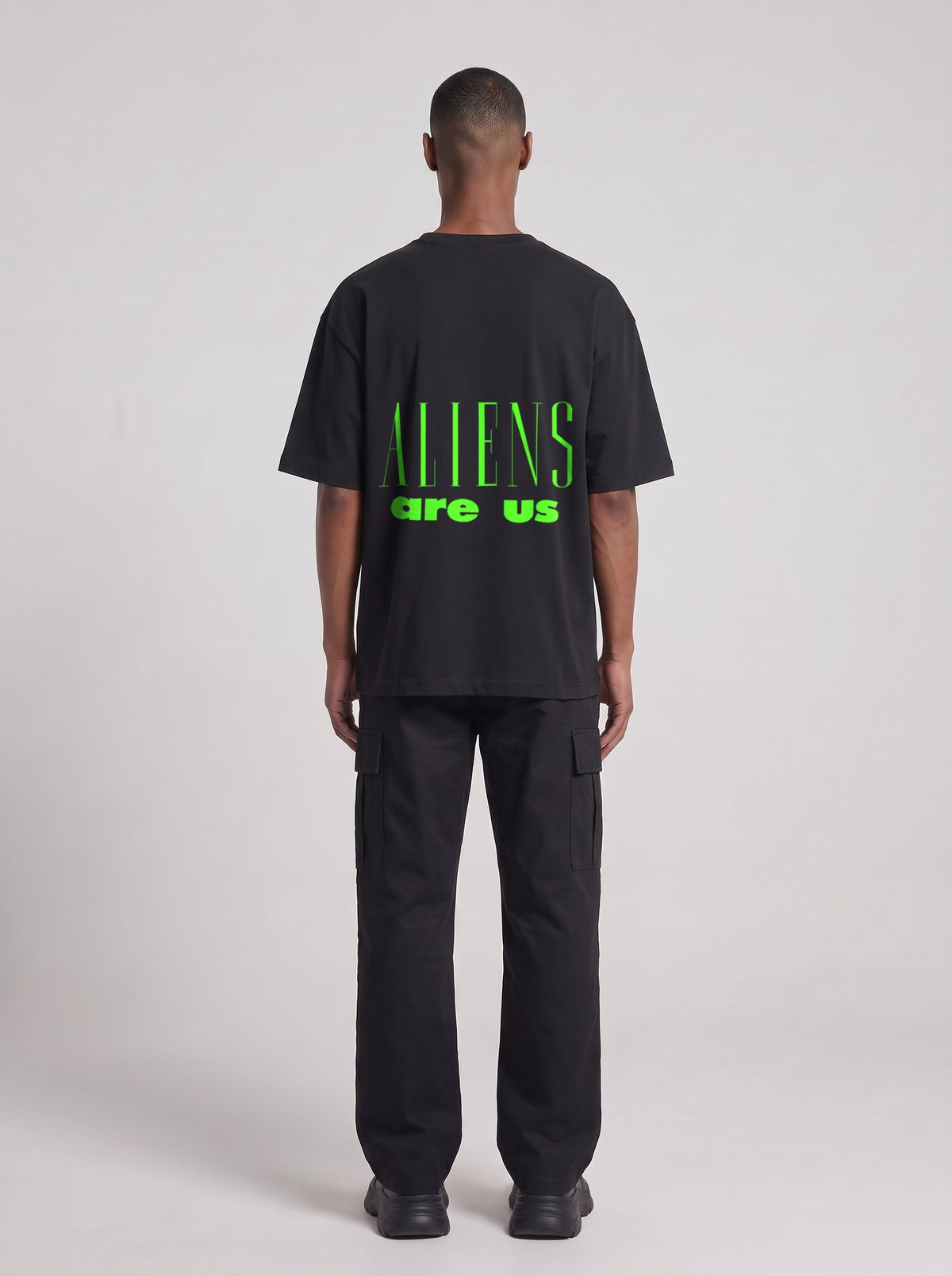 Aliens Are Us Neon — Drop Shoulder T-Shirt in Black Beauty, back, worn by male model