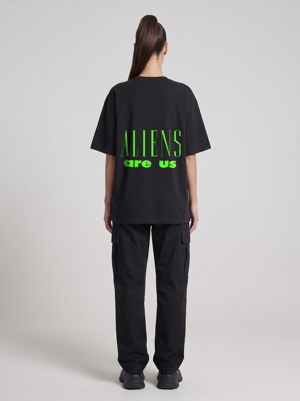 Aliens Are Us Neon — Drop Shoulder T-Shirt in Black Beauty, back, worn by female model