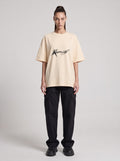 Anomalous Experience — Drop Shoulder T-Shirt in Light Apricot, front, worn by female model
