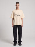 Just Cause — Drop Shoulder T-Shirt in Light Apricot, front, worn by female model