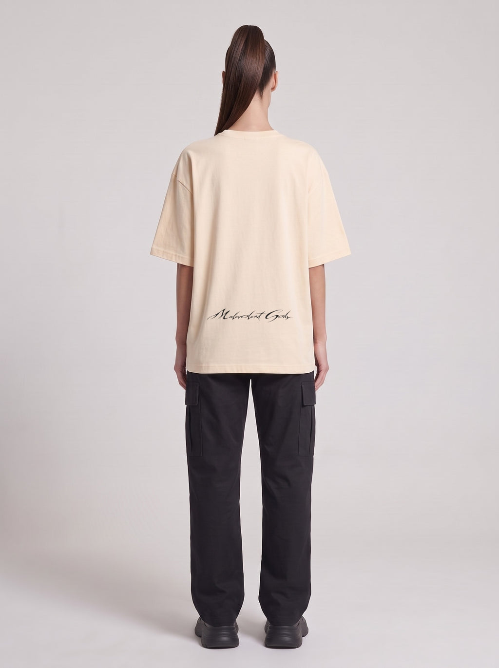 Monolith — Drop Shoulder T-Shirt in Light Apricot, back, worn by female model