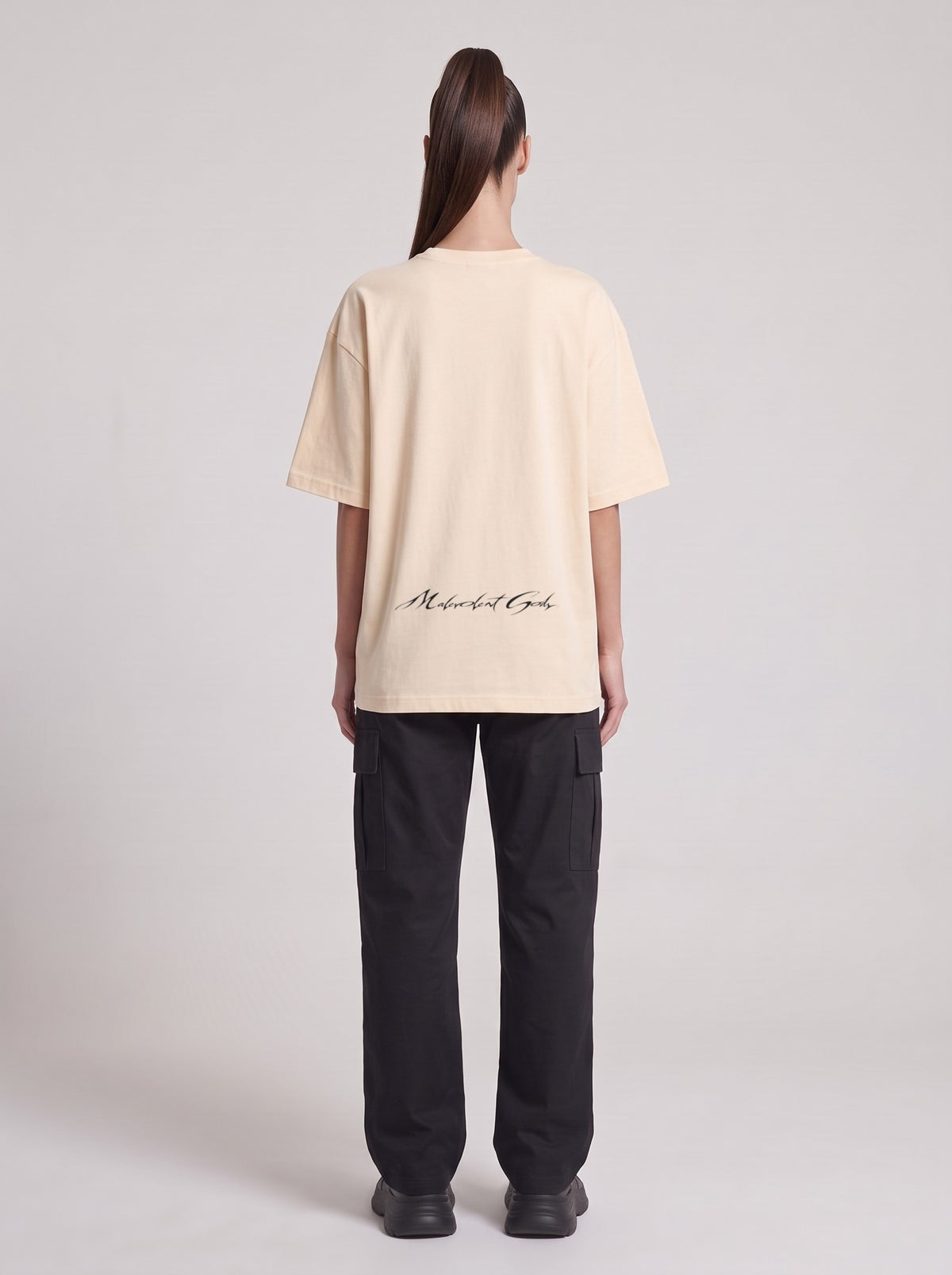 Monolith — Drop Shoulder T-Shirt in Light Apricot, back, worn by female model