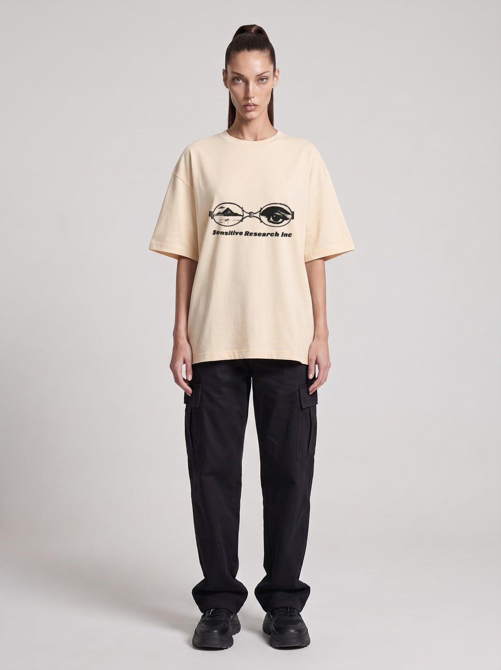 Sensitive Research — Drop Shoulder T-Shirt in Light Apricot, front, worn by female model