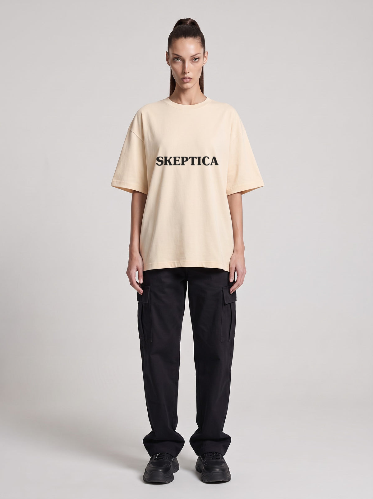 Skeptica — Drop Shoulder T-Shirt in Light Apricot, front, worn by female model