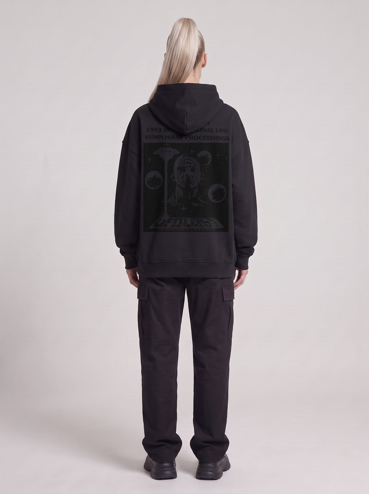 Symposium 1993 — Boxy Hoodie in Black, back, worn by female model