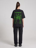 Temporary Resident Society Neon — Drop Shoulder T-Shirt in Black Beauty, back, worn by female model