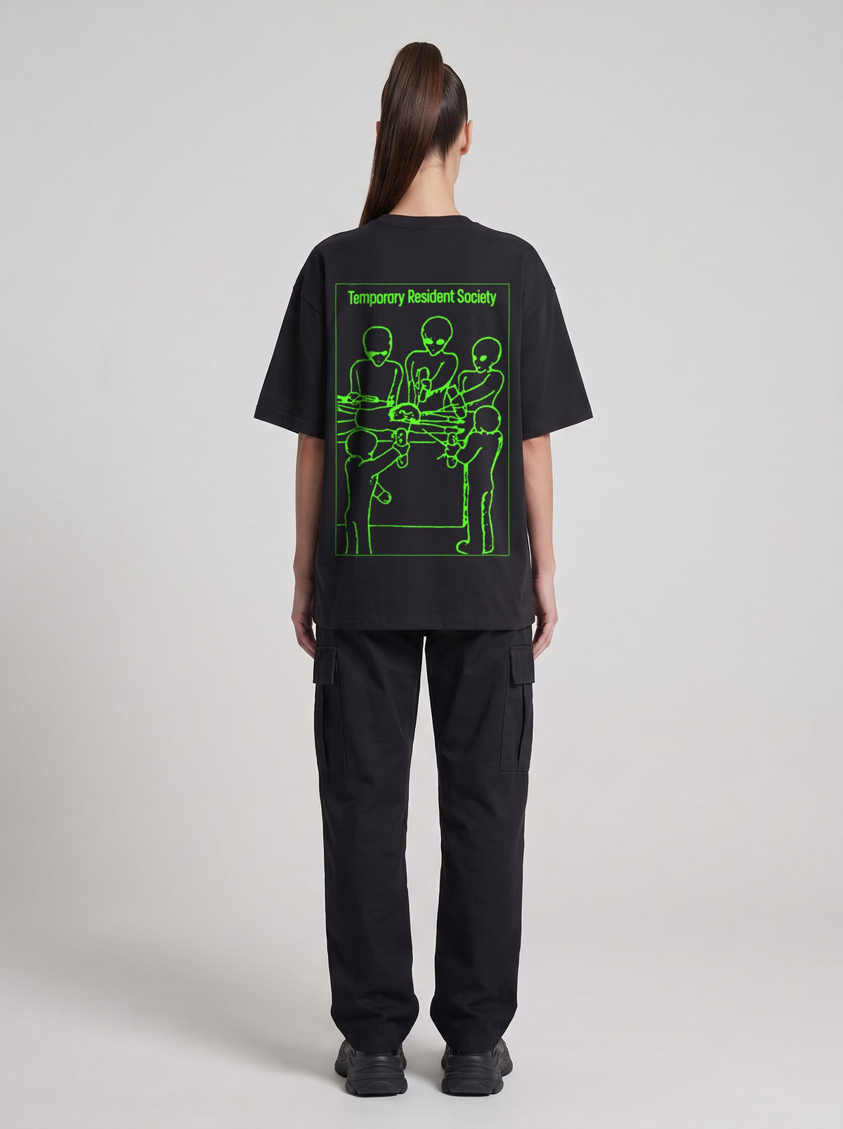 Temporary Resident Society Neon — Drop Shoulder T-Shirt in Black Beauty, back, worn by female model