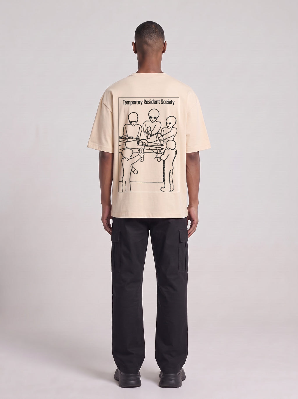 Temporary Resident Society — Drop Shoulder T-Shirt in Light Apricot, back, worn by male model